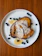 A warm plate of golden French toast with fresh berries and a steaming latte beside it.