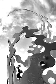 Metal artwork featuring abstract forms reflecting nature's flow.