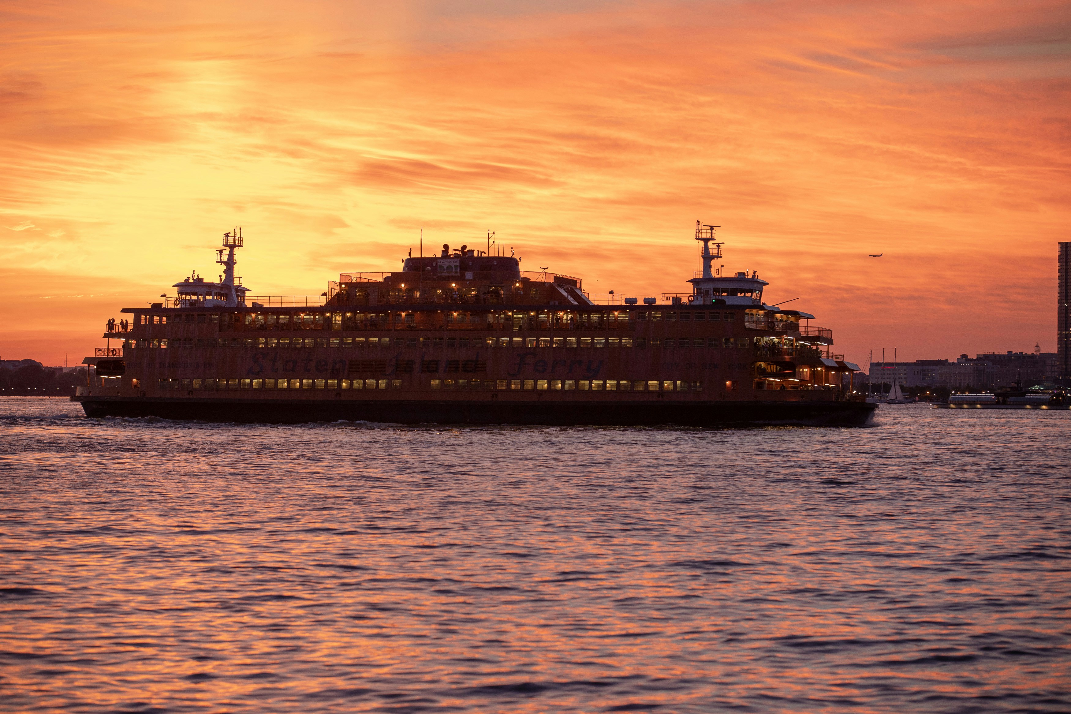 white and black ship on sea during sunset