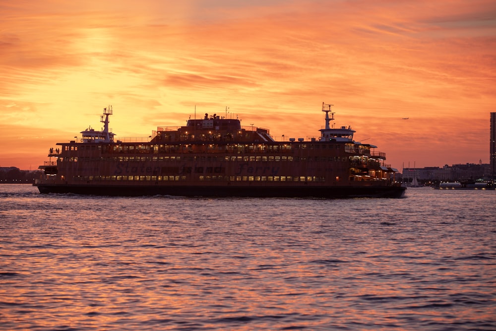 white and black ship on sea during sunset