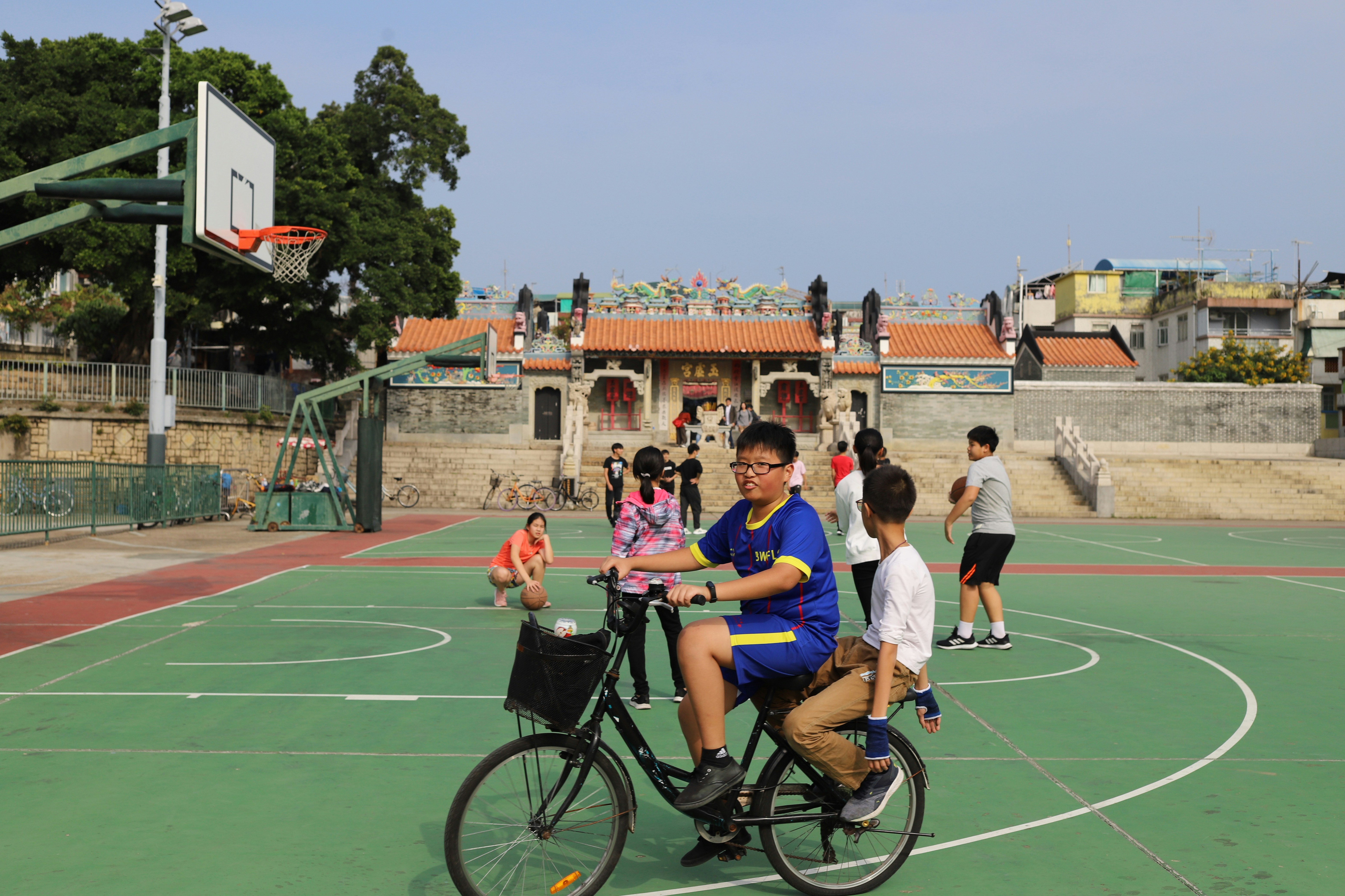 people sitting on green field during daytime