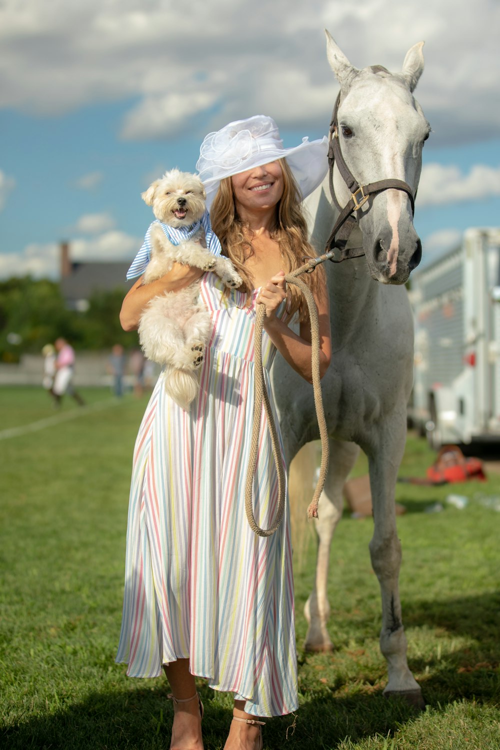 woman in white dress riding horse during daytime