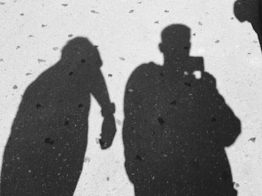 silhouette of 3 men standing on snow covered ground