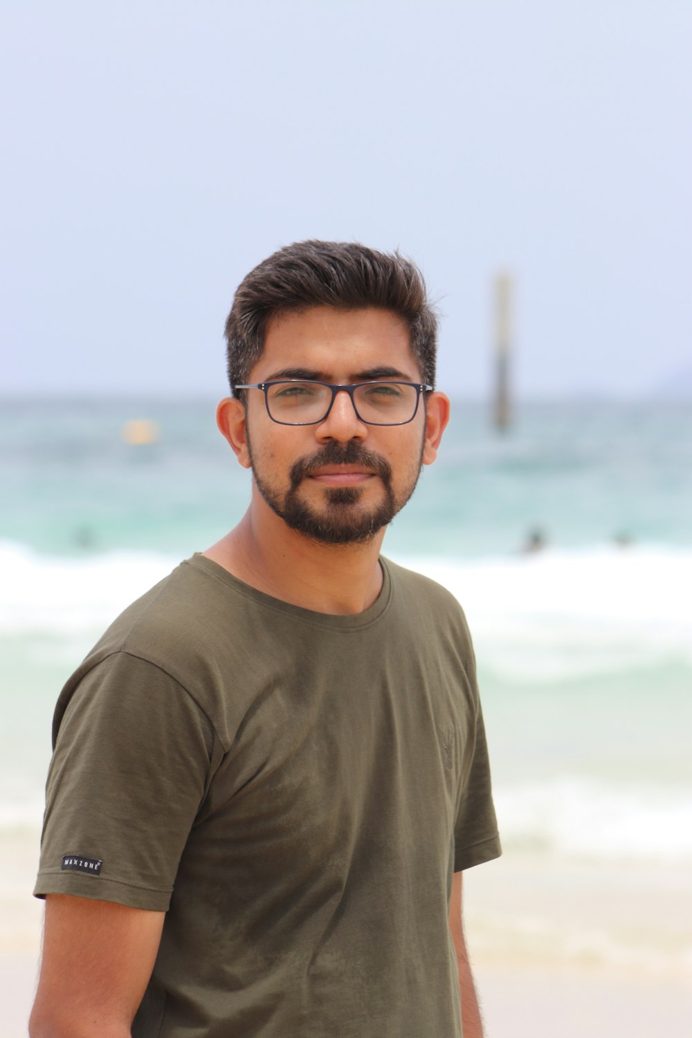 man in black framed eyeglasses and gray crew neck shirt