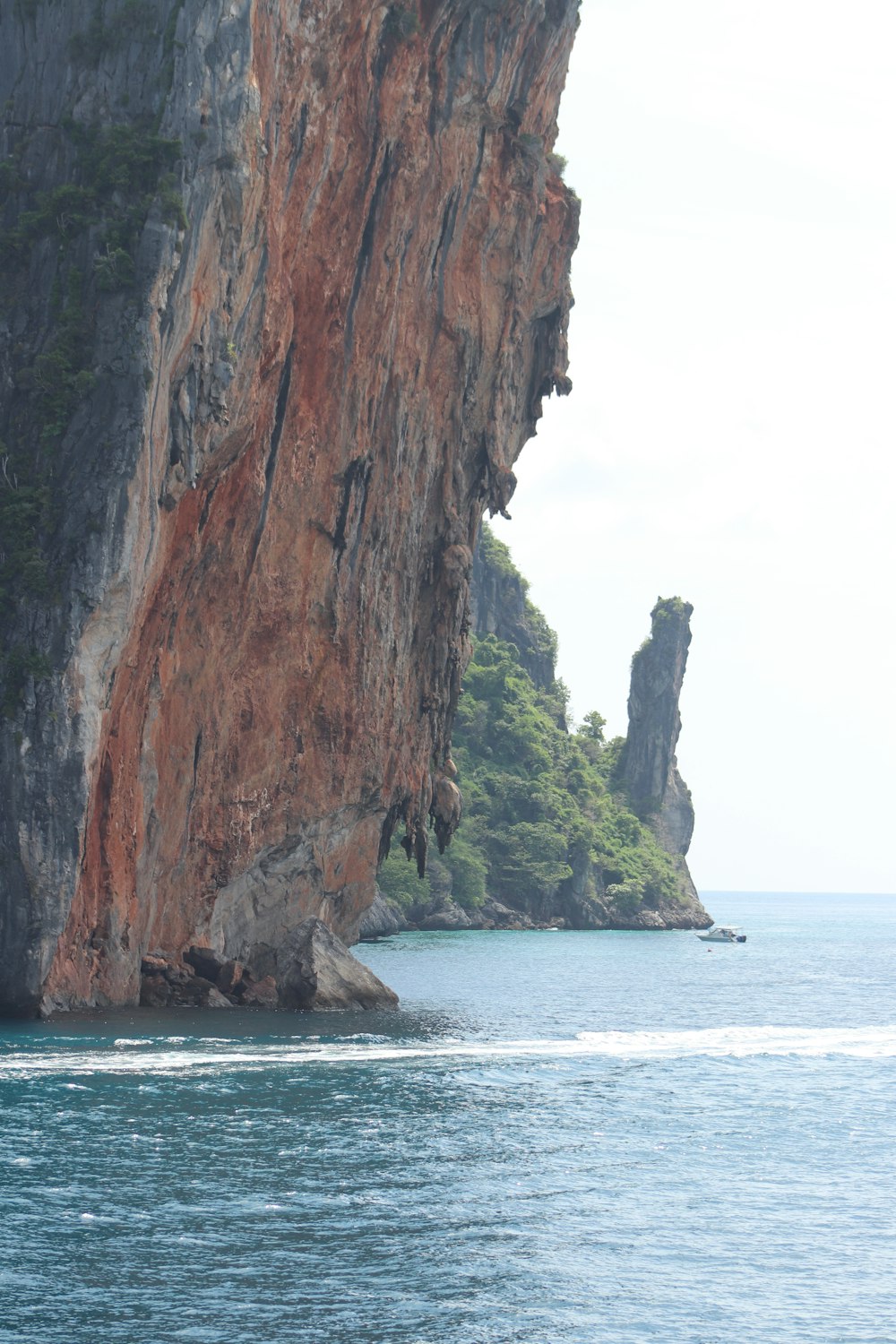 brown rock formation on sea during daytime