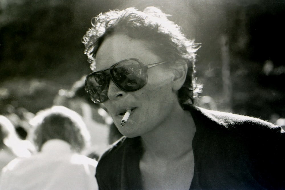 woman wearing black sunglasses and white floral head band