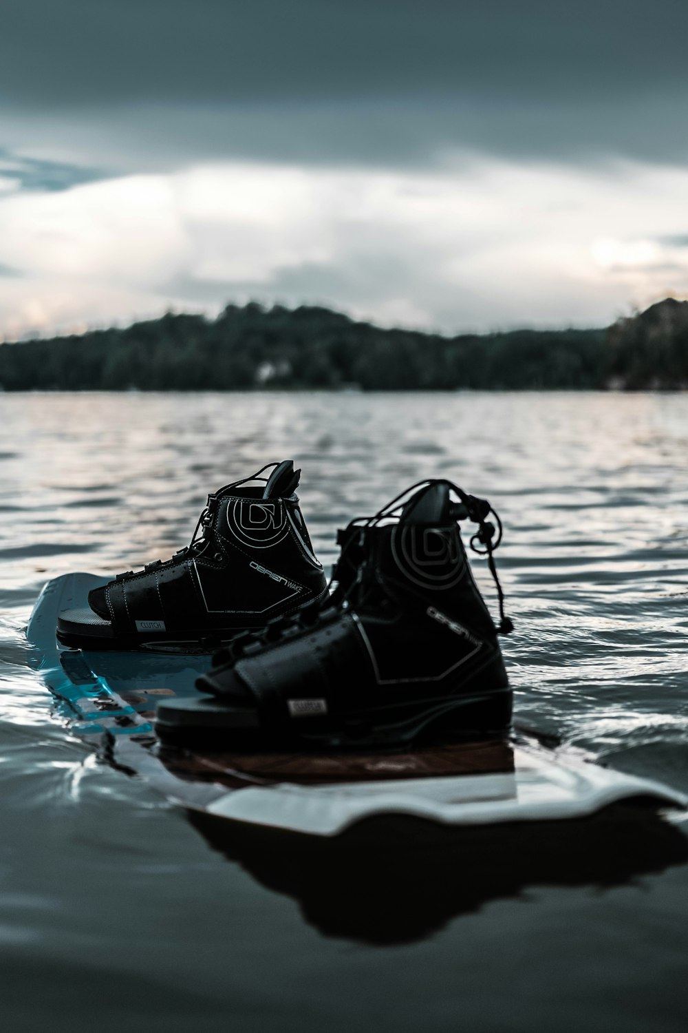 black and orange life vest on blue and white kayak on body of water during daytime