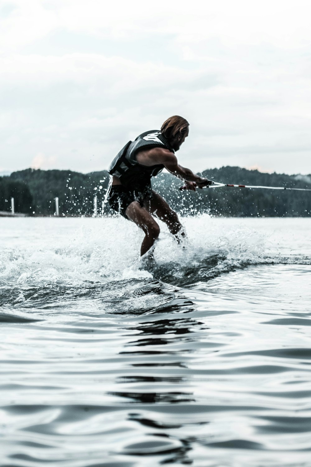 man in black shorts running on water during daytime