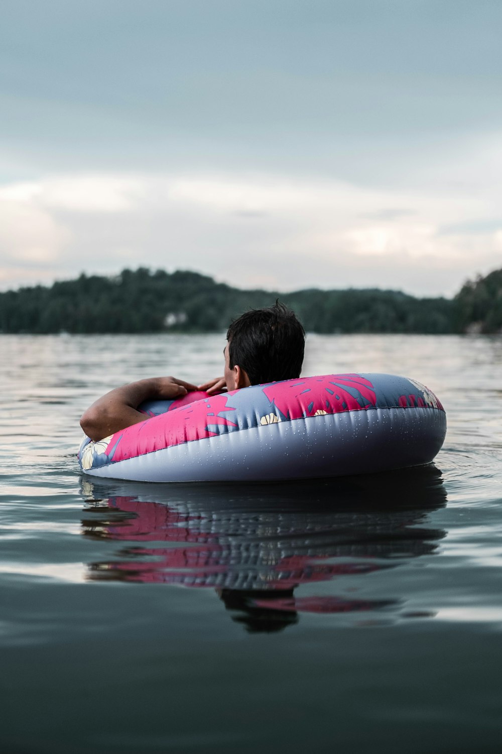 woman in red and white inflatable ring on water during daytime