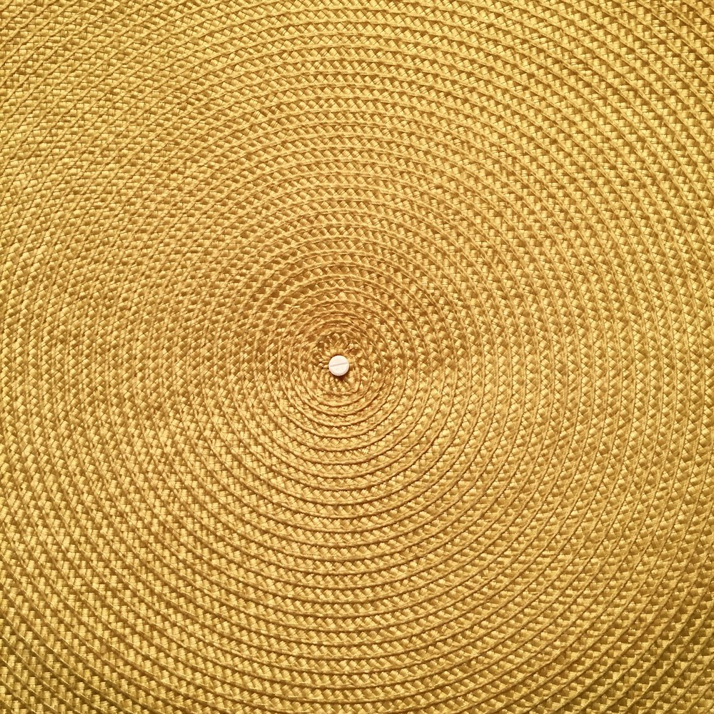 white round ornament on brown textile