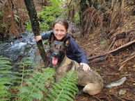 A service dog and a child with hypertension sharing a moment of companionship outdoors.