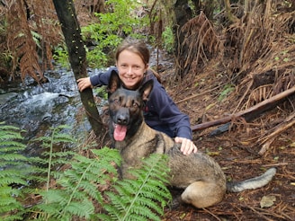A service dog and a child with hypertension sharing a moment of companionship outdoors.