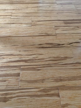 SPC flooring with a natural wood look, installed seamlessly in a bright kitchen