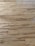 Wooden floor with a natural grain pattern and a light brown color. The surface appears smooth with slightly visible seams between the planks, giving it a polished look.