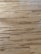 Wooden floor with a natural grain pattern and a light brown color. The surface appears smooth with slightly visible seams between the planks, giving it a polished look.