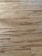 Wooden floor with a natural grain pattern and a light brown color. The surface appears smooth with slightly visible seams between the planks, giving it a polished look.