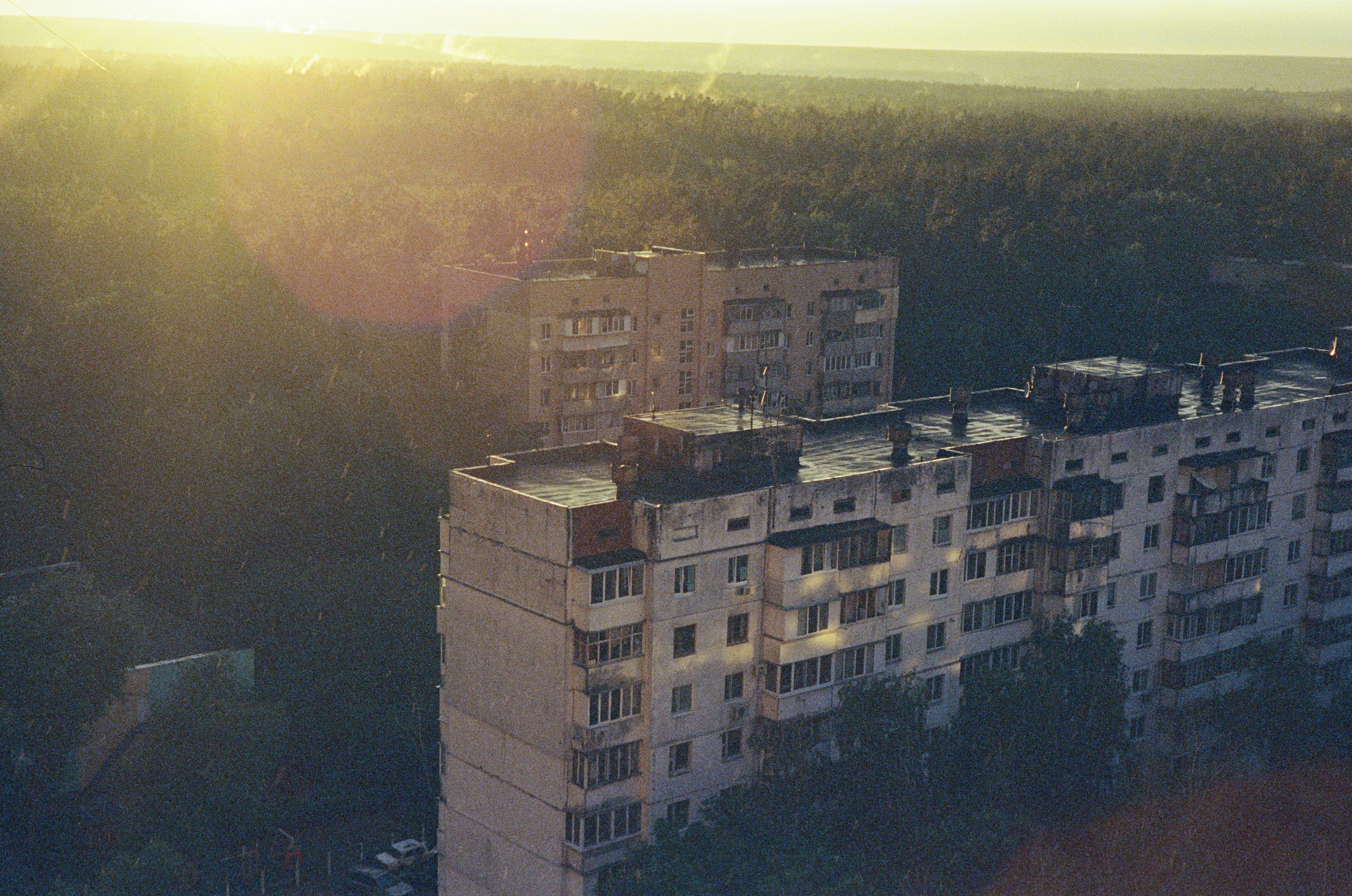 a very tall building sitting next to a forest