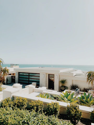 white and brown concrete building near green trees during daytime