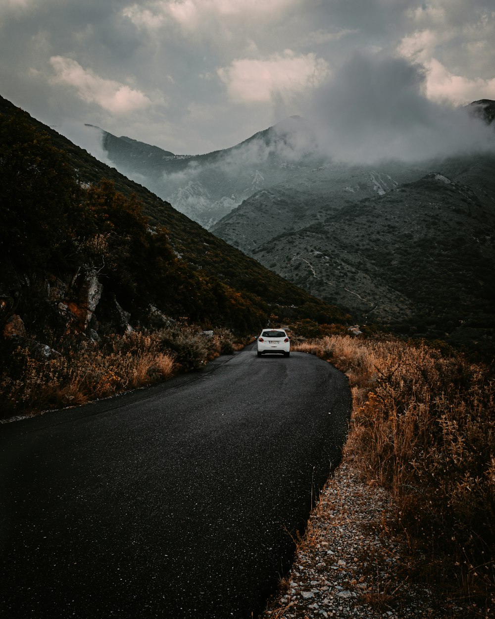 white car on road near mountain during daytime