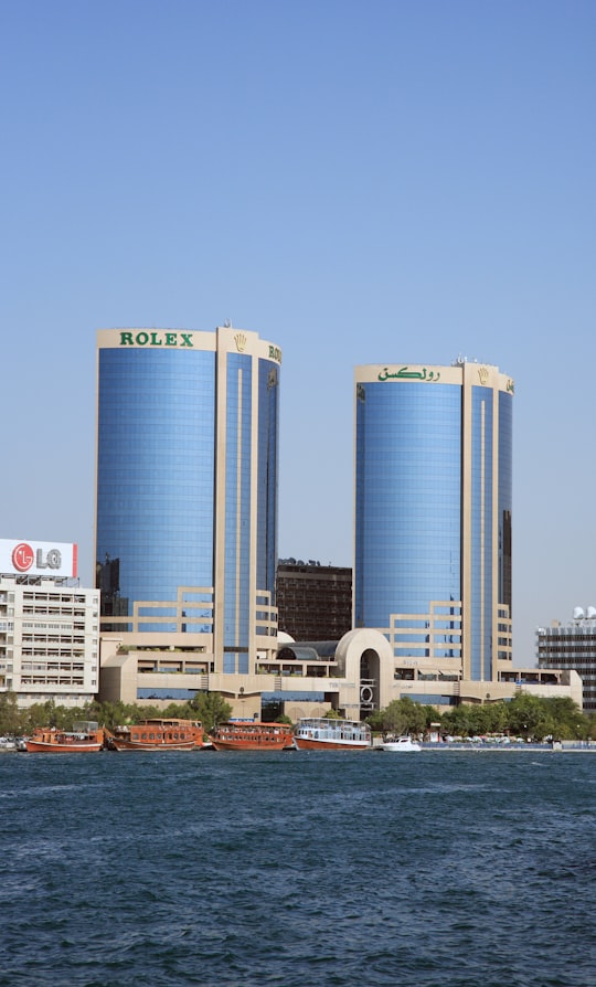 white and blue concrete building near body of water during daytime in Twin Towers United Arab Emirates