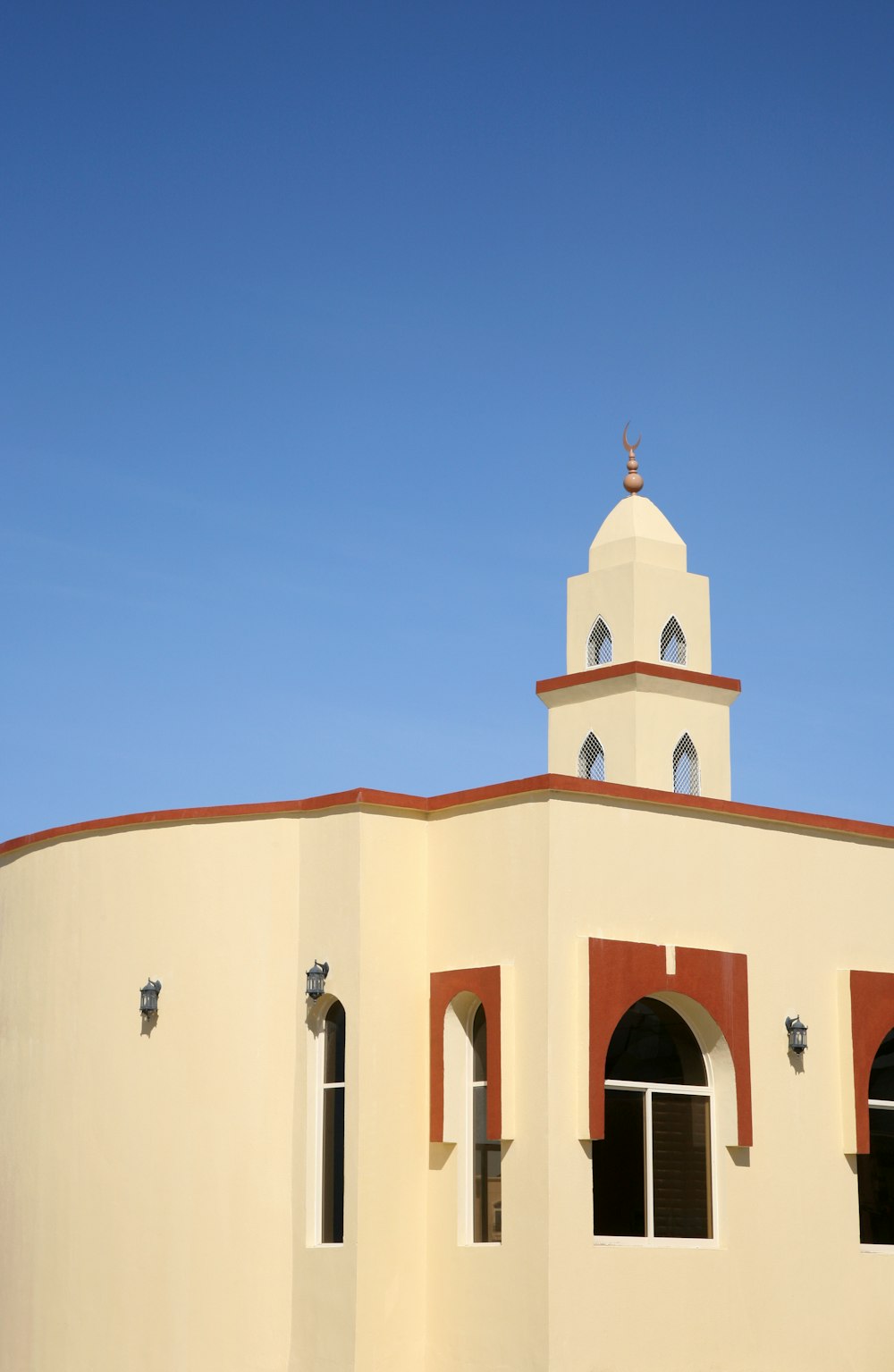 beige concrete building under blue sky during daytime