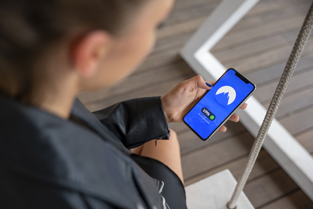 boy in black long sleeve shirt holding blue and white nintendo switch