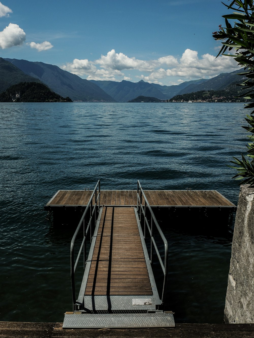 brown wooden dock on lake during daytime