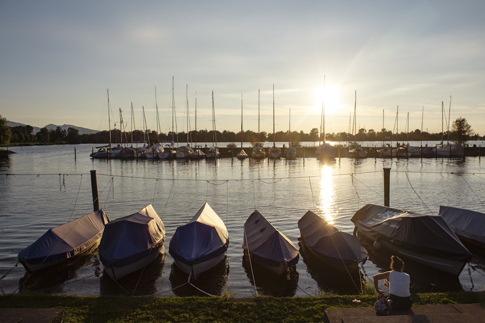 boats on water near dock during sunset