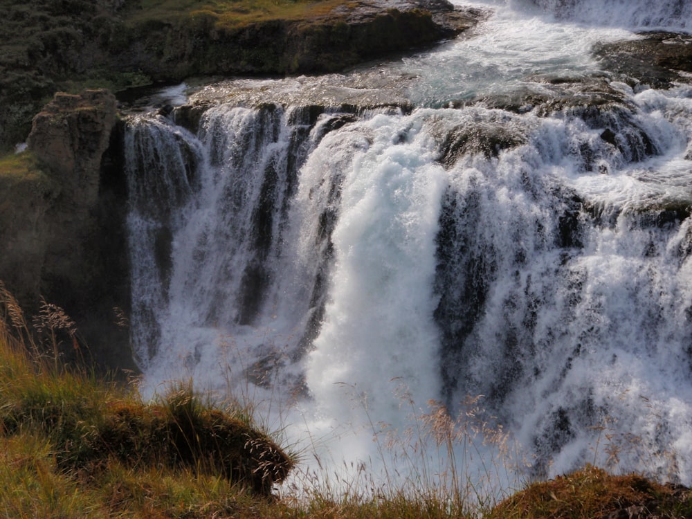 water falls on brown grass field