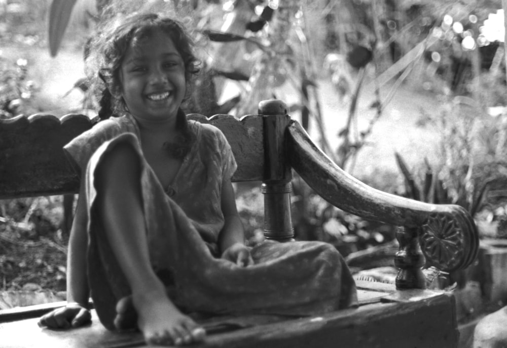 grayscale photo of woman sitting on chair