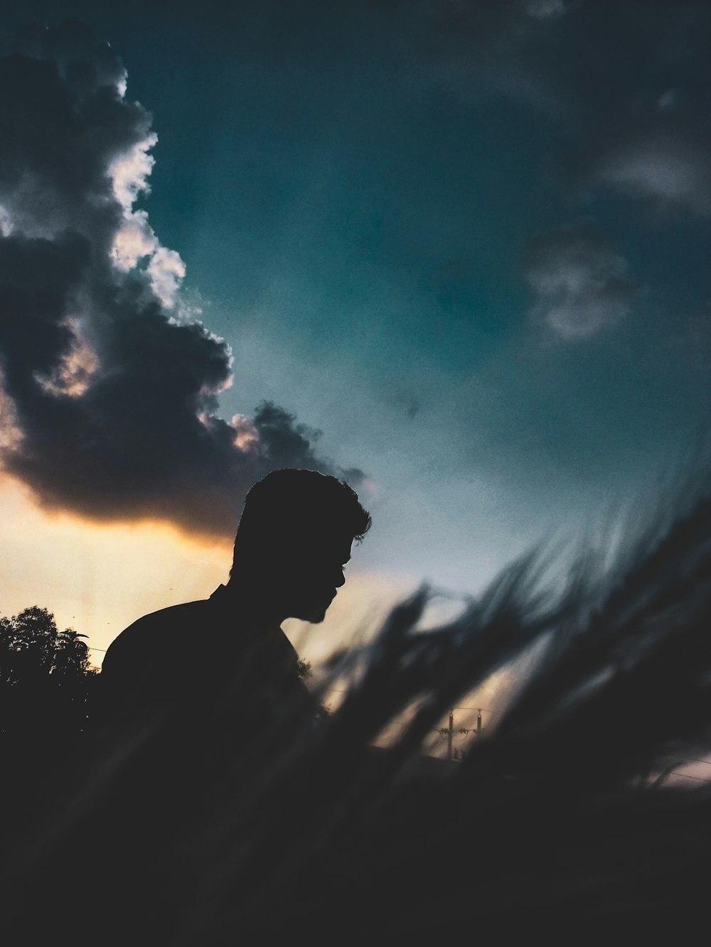 silhouette of man under blue sky and white clouds