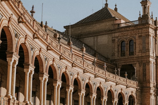 brown concrete building under blue sky during daytime in Plaza de España Spain