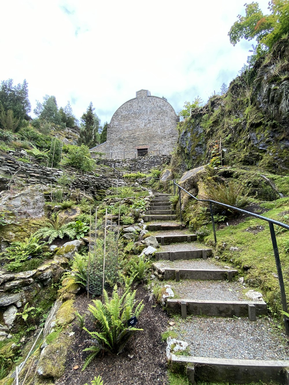 gray concrete stairs near brown rocky mountain during daytime