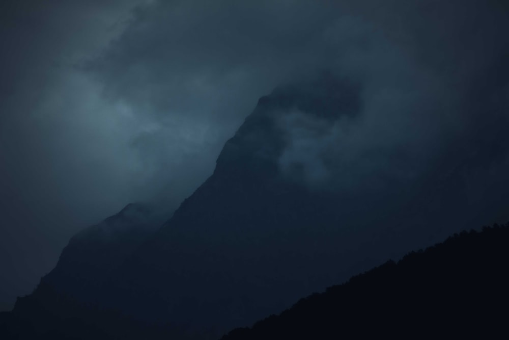 black mountain under white clouds