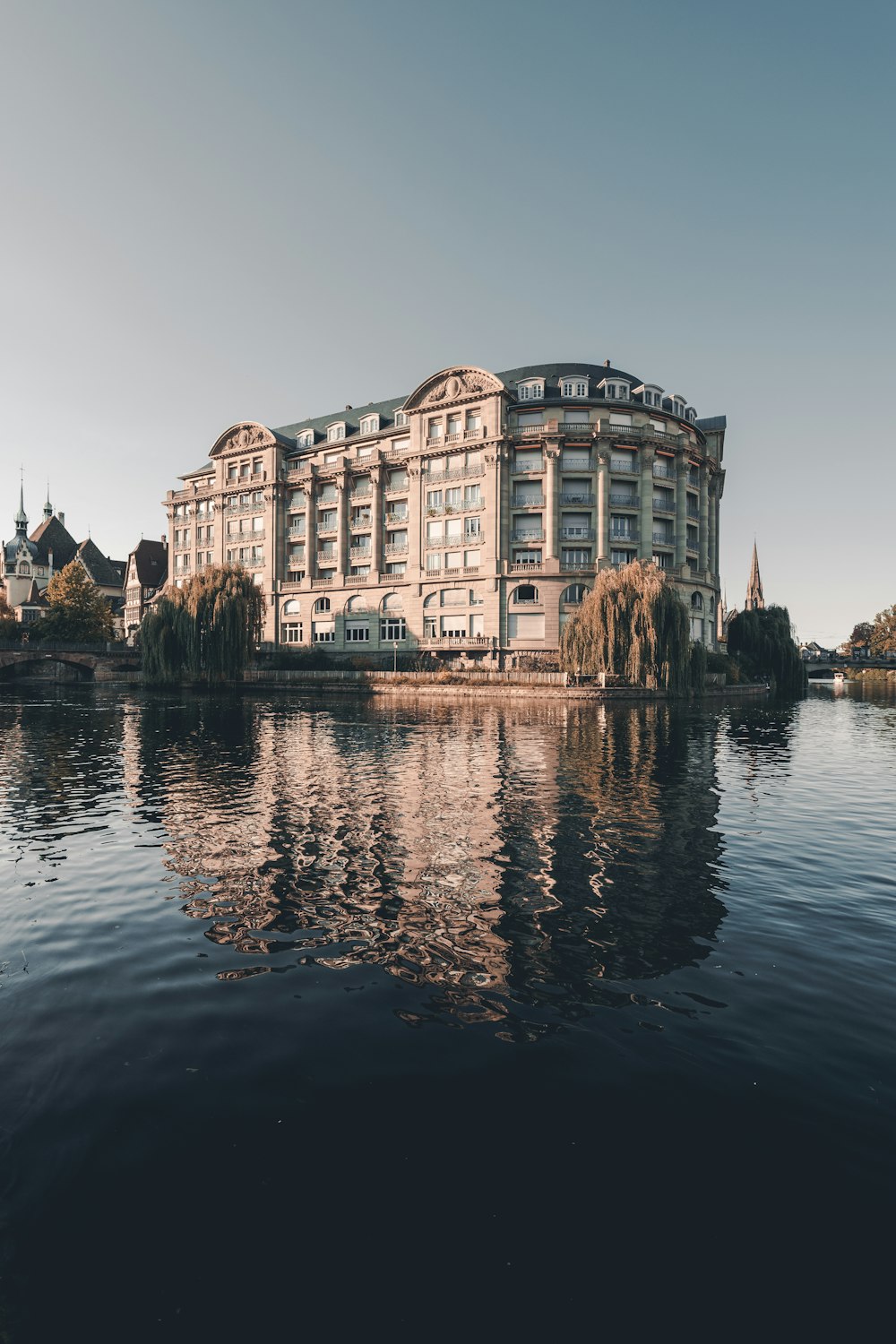 brown concrete building near body of water during daytime