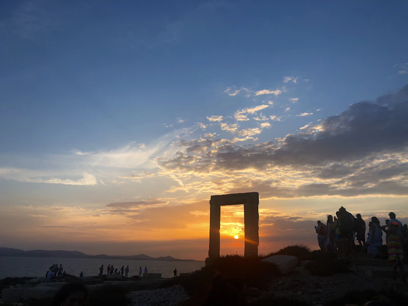 The Portara, a marble temple doorway, silhouetted at sunset