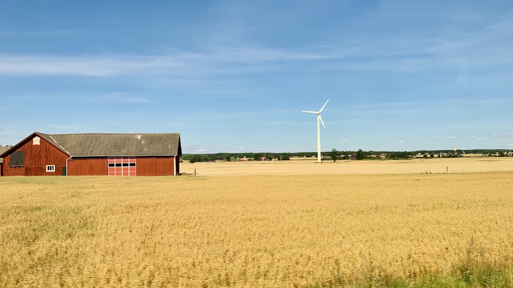 brown barn house on brown field under blue sky during daytime