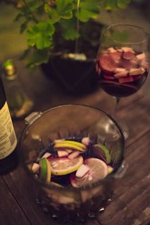 Refreshing pitcher of sangria filled with colorful fruits on a sunlit table
