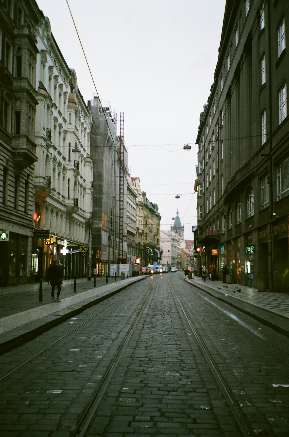 cars on road between buildings during daytime