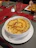 A happy customer enjoying a cheesy mac and cheese burrito at home.