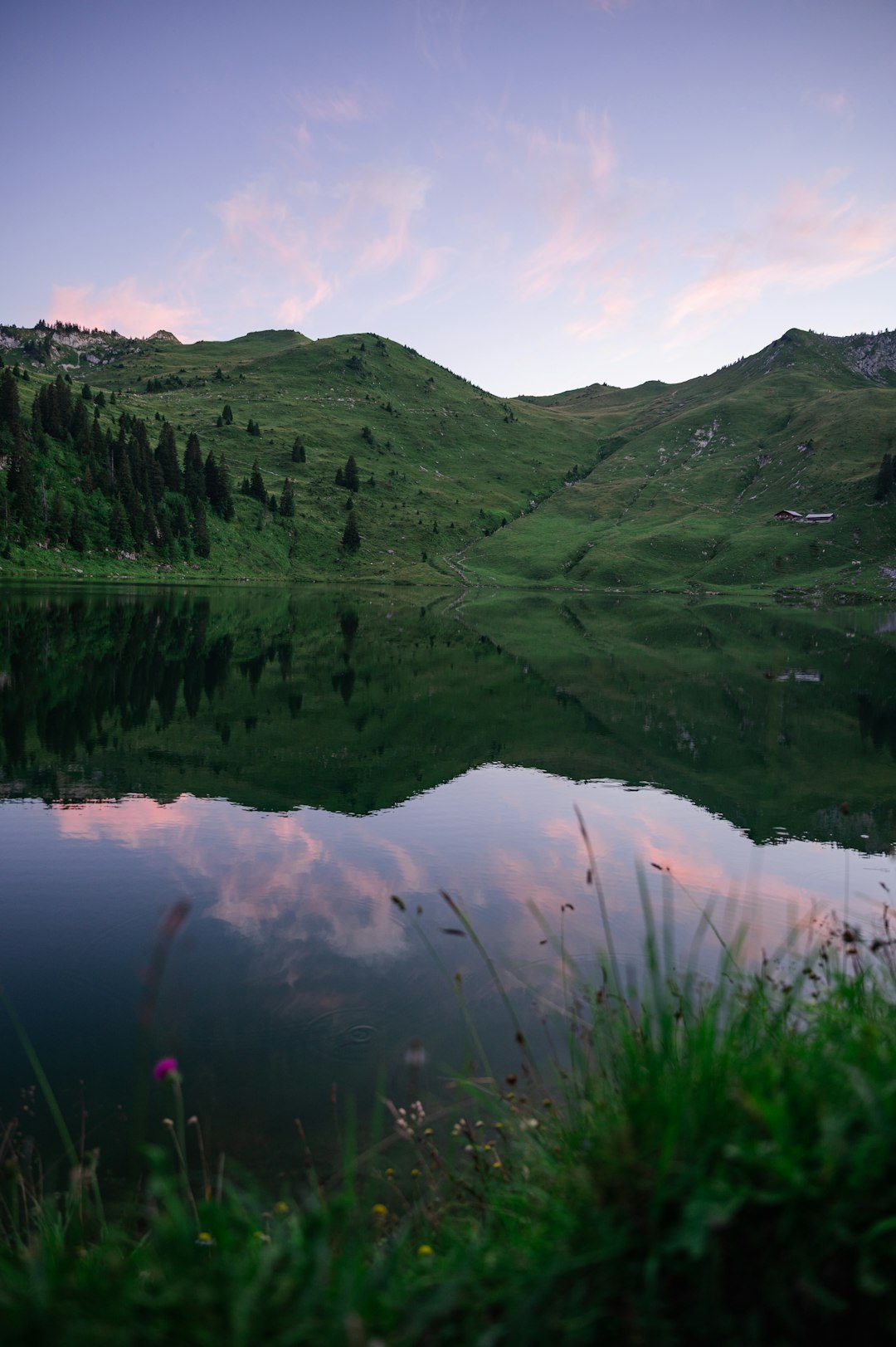 green mountains beside lake during daytime