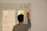 An engineer sketching floating wind turbine concepts on a transparent board filled with calculations.