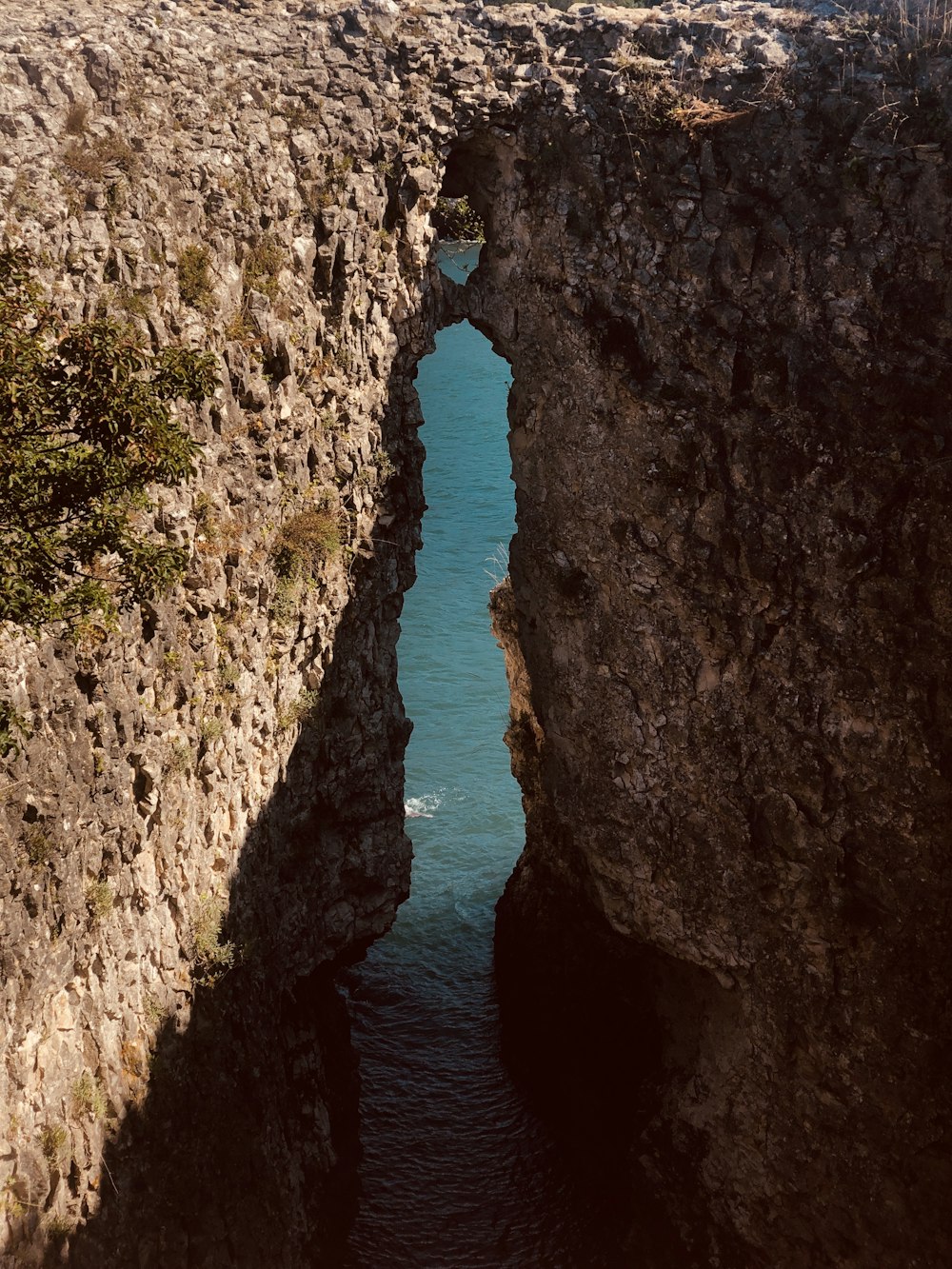 brown rock formation beside body of water during daytime