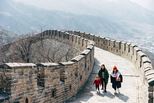 people walking on concrete brick wall during daytime in Beijing China