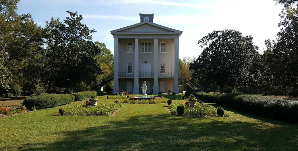 white concrete building near green grass field during daytime