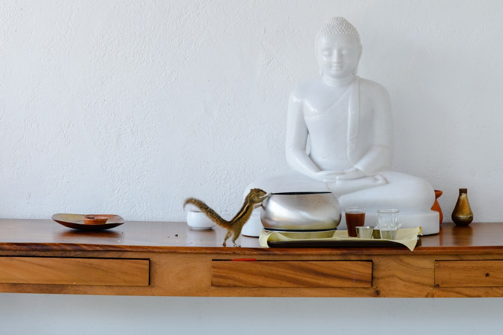white ceramic figurine on brown wooden table