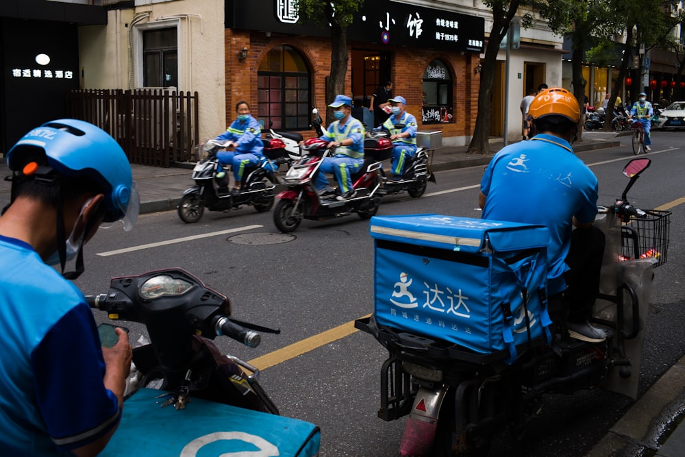 man in blue helmet riding on blue motorcycle during daytime