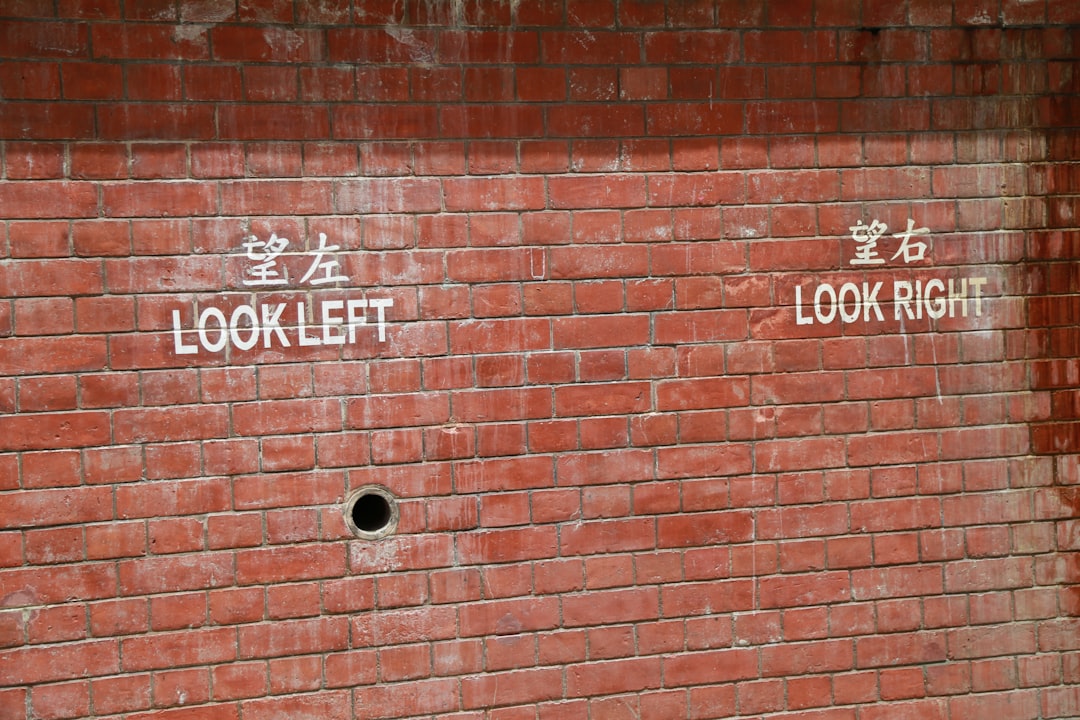 brown brick wall with no smoking sign