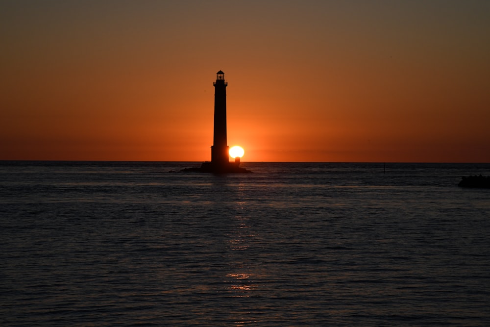 silhouette of lighthouse during sunset