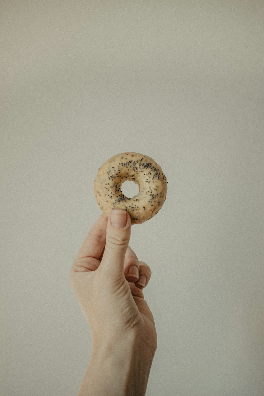 person holding doughnut with chocolate filling
